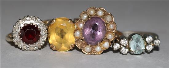 Three 9ct gold and gem set rings and a white metal ring.